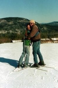 Sue and Jim Martin hug on downhill skis, an accomplishment!